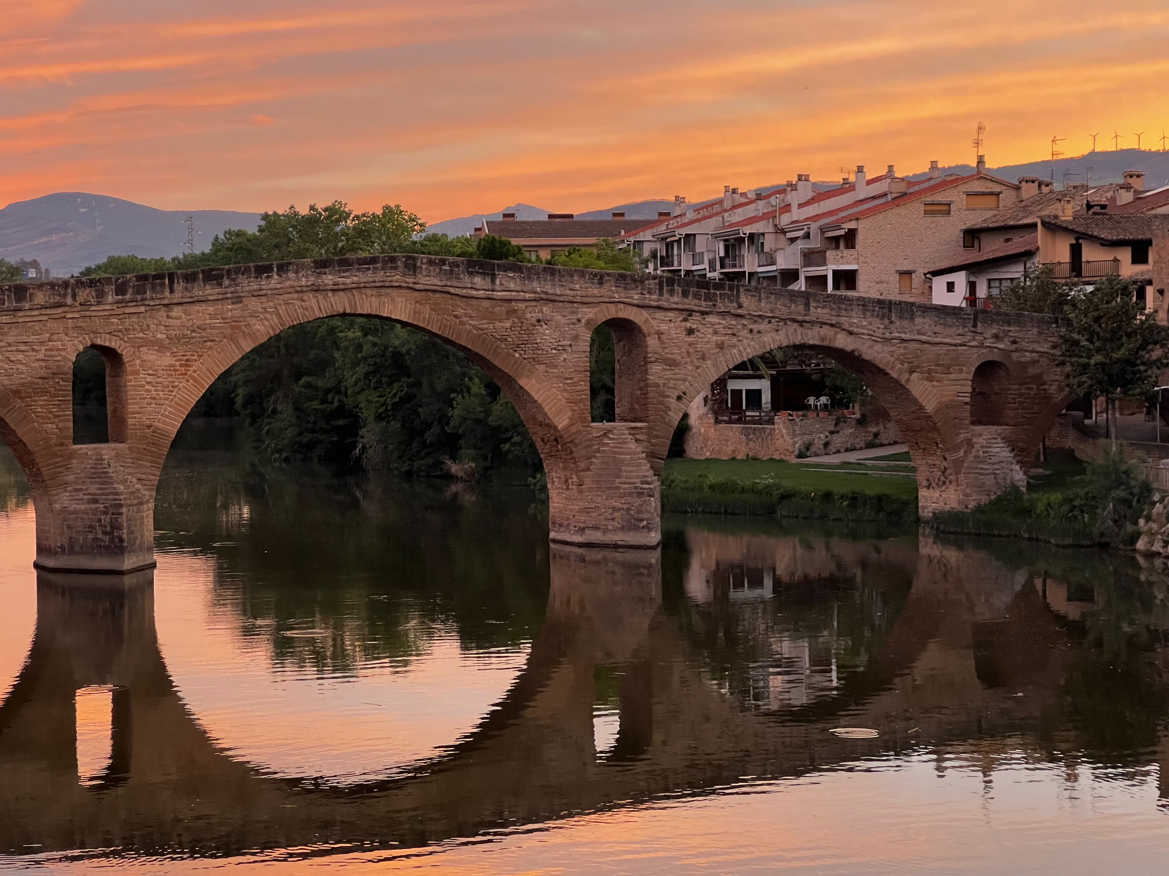 Pilgrims walking the Camino de Santiago in Galicia at golden hour